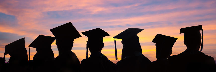 graduates at sunset